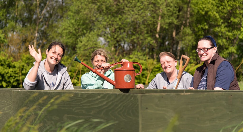 Group of people with a watering can